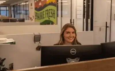 Prairie Fresh employee working at a computer in an office setting