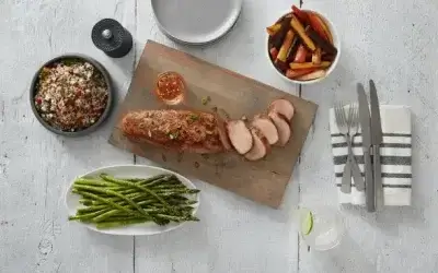 Sliced Prairie Fresh® pork tenderloin with roasted vegetables, quinoa salad, and asparagus